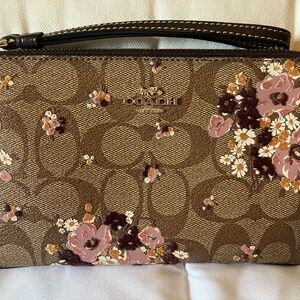 COACH zipper wristlet.